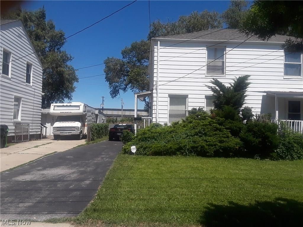 View of side of property with a lawn