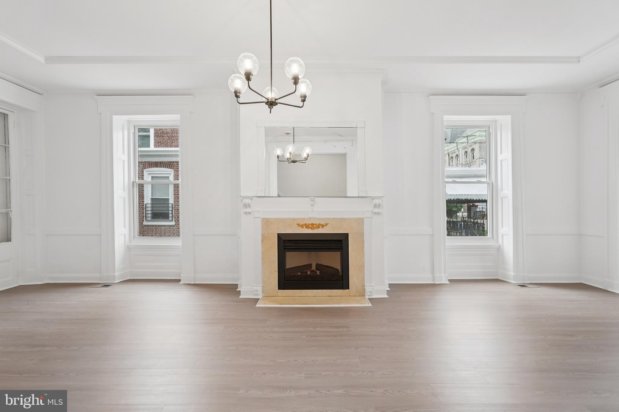 200 East Price Street Philadelphia, PA 19144 - Photo 11 of 29 a view of a livingroom with wooden floor a fireplace and windows