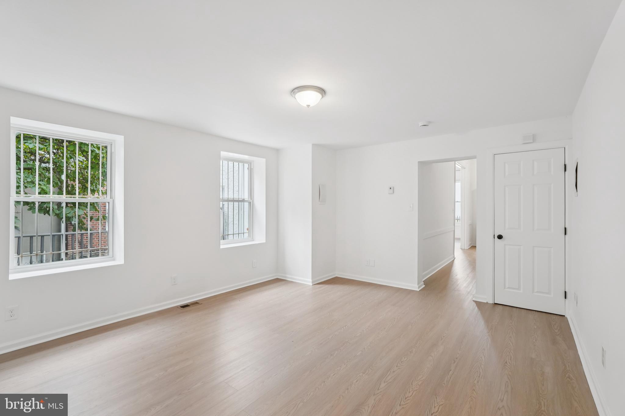 200 East Price Street Philadelphia, PA 19144 - Photo 12 of 29 a view of an empty room with wooden floor and windows