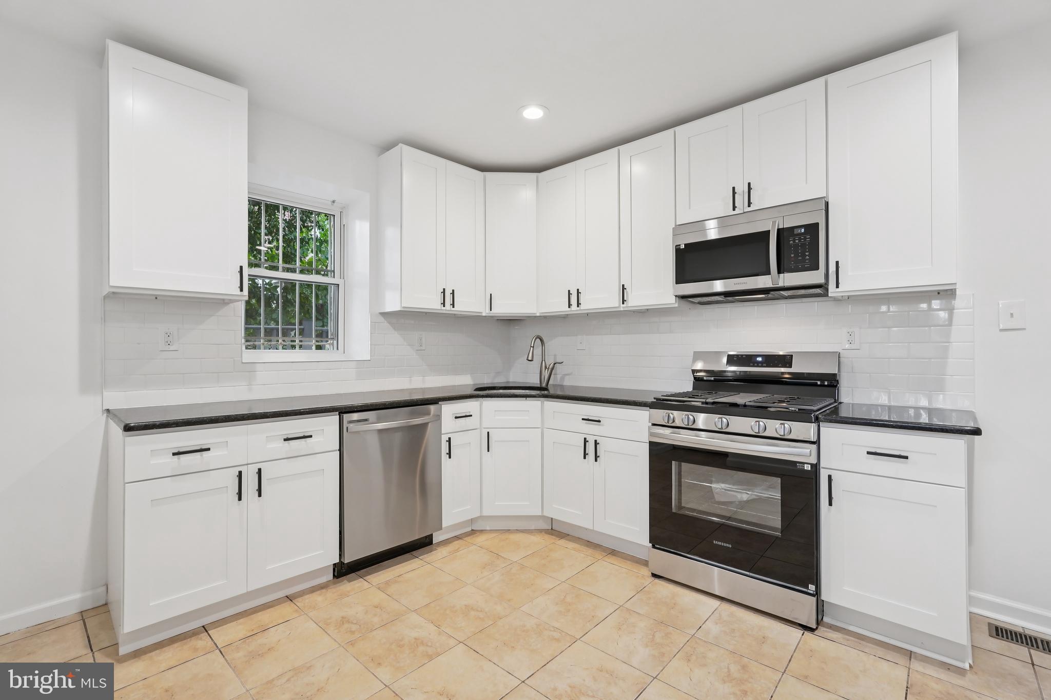 200 East Price Street Philadelphia, PA 19144 - Photo 14 of 29 a kitchen with cabinets stainless steel appliances and a sink