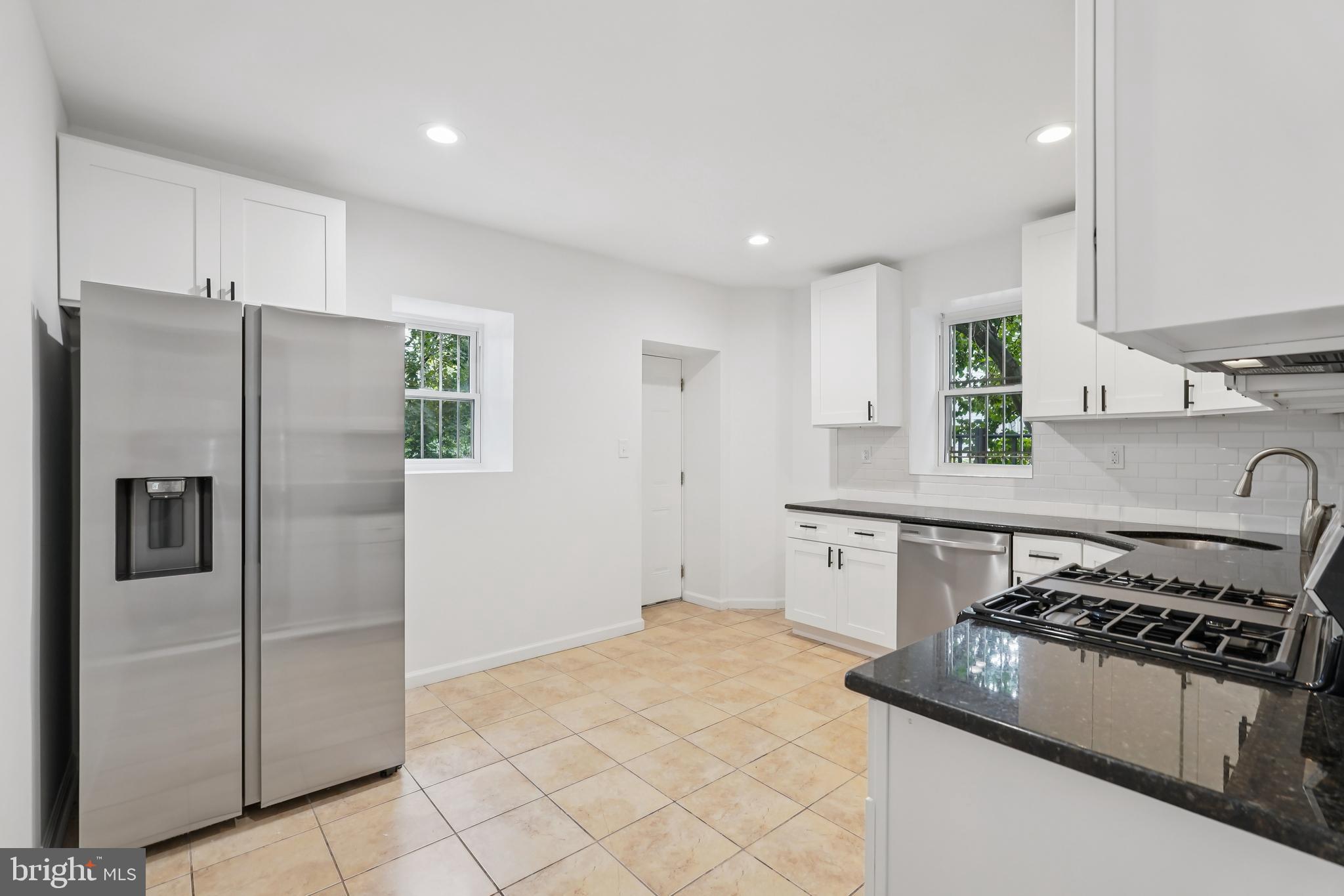 200 East Price Street Philadelphia, PA 19144 - Photo 15 of 29 a kitchen with stainless steel appliances granite countertop a refrigerator stove and sink