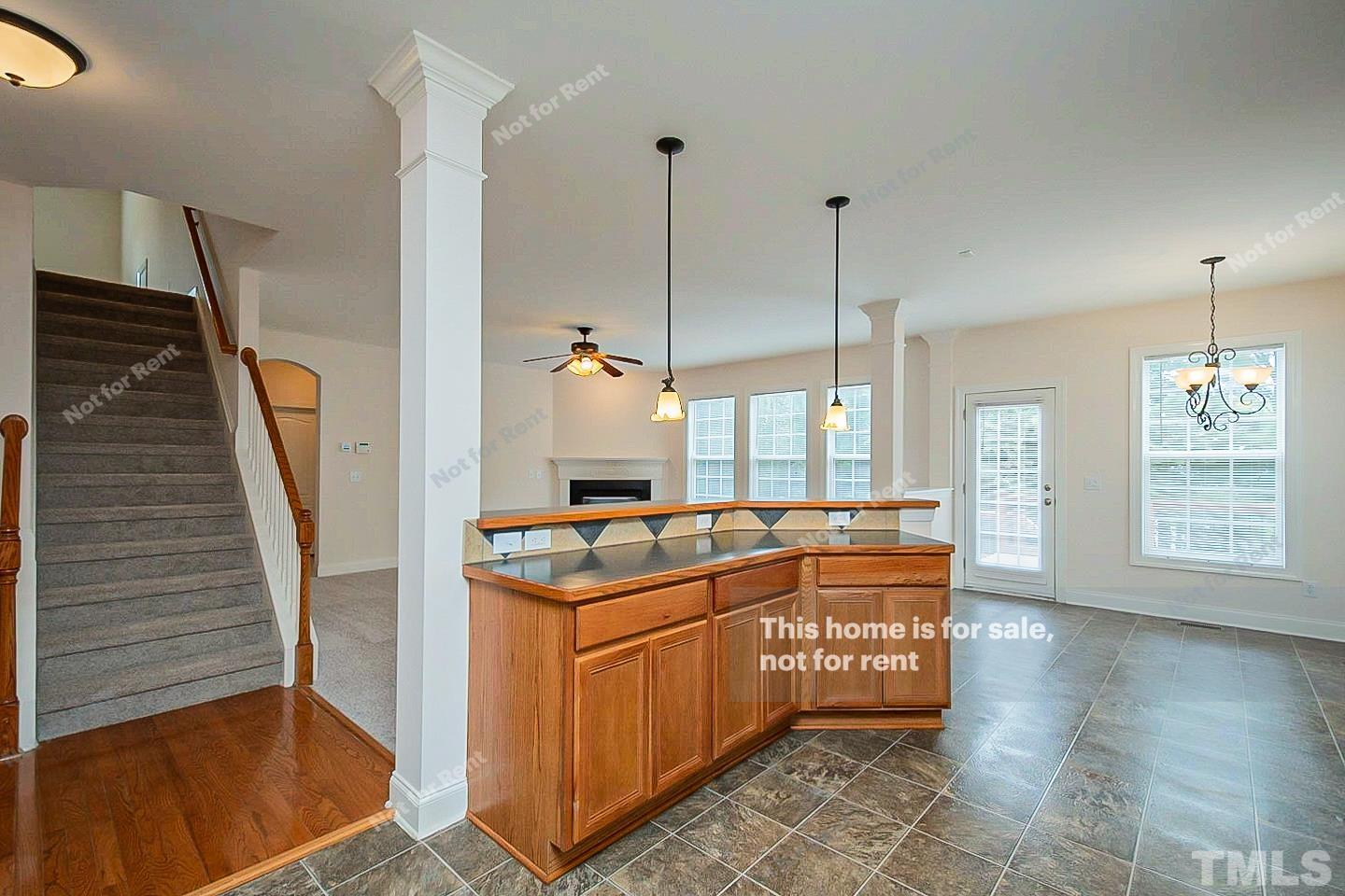 10129 Darling Street Raleigh, NC 27613 - Photo 8 of 24 a kitchen with stainless steel appliances granite countertop a stove a sink and a wooden floors