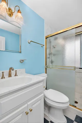 a bathroom with a sink a mirror and a toilet
