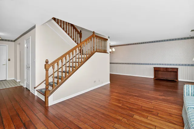 a view of entryway and hall with wooden floor