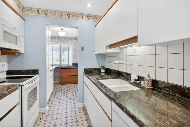 a kitchen with a sink stove and cabinets