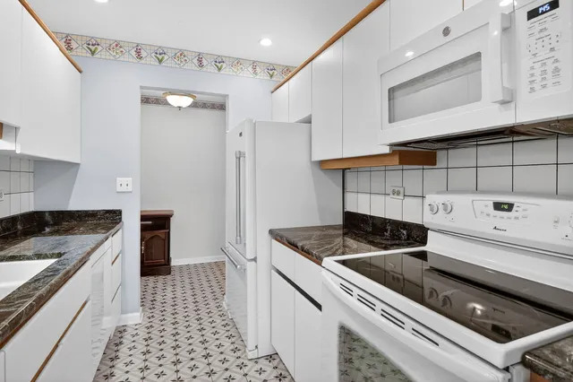 a kitchen with granite countertop a stove and a sink