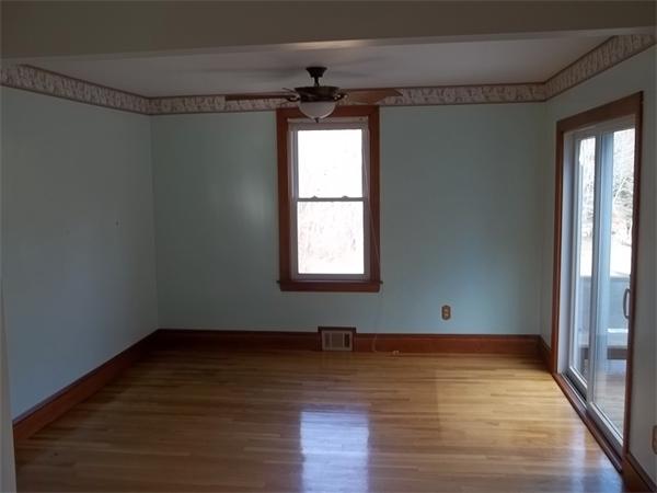 87 Howland Road Lakeville, MA 02347 - Photo 5 of 8 a view of an empty room with wooden floor and a window