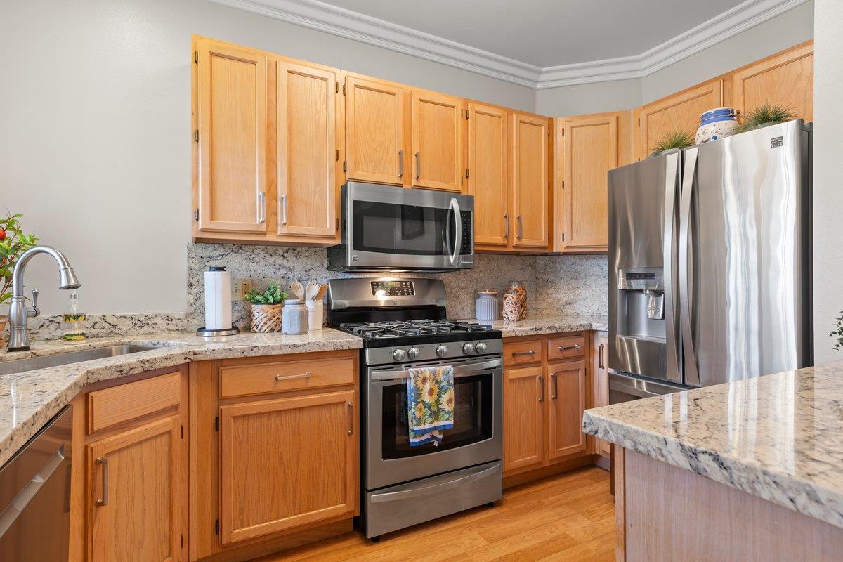 160 Troon Way Half Moon Bay, CA 94019 - Photo 12 of 28 a kitchen with granite countertop a stove top oven microwave and refrigerator