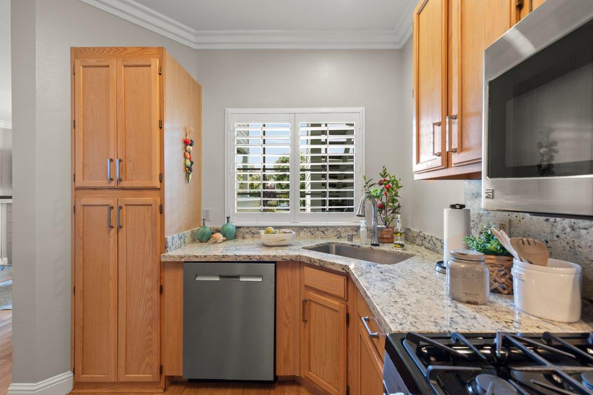 160 Troon Way Half Moon Bay, CA 94019 - Photo 13 of 28 a kitchen with stainless steel appliances granite countertop a sink stove and cabinets