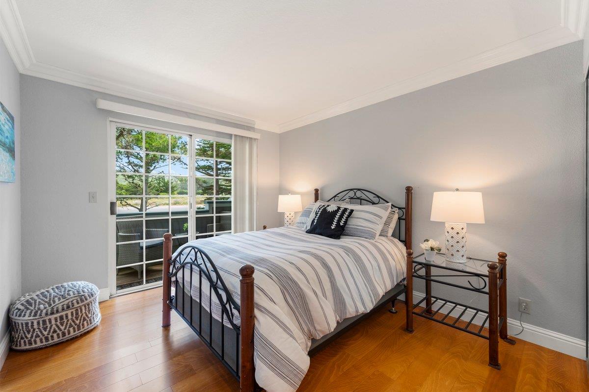 160 Troon Way Half Moon Bay, CA 94019 - Photo 21 of 28 a bedroom with a bed and wooden floor