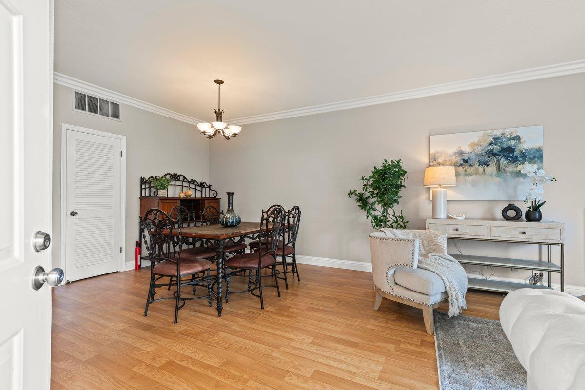 160 Troon Way Half Moon Bay, CA 94019 - Photo 4 of 28 a dining room with furniture potted plants and wooden floor