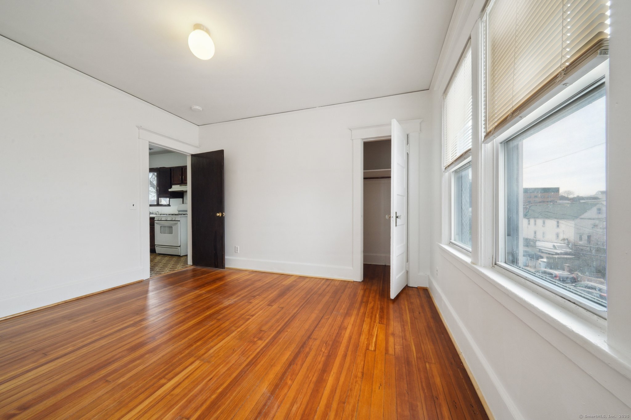 17 Alden Street Stamford, CT 06902 - Photo 15 of 34 a view of an empty room with wooden floor and a window