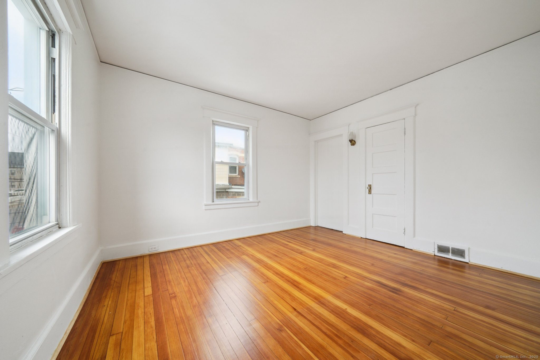 17 Alden Street Stamford, CT 06902 - Photo 16 of 34 a view of empty room with wooden floor and fan