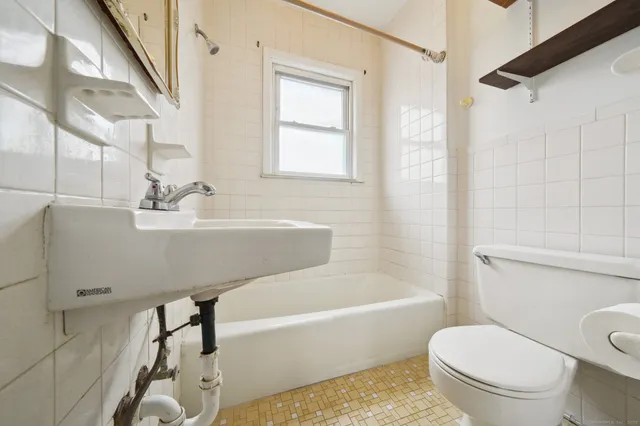 a bathroom with a sink a toilet and a bathtub