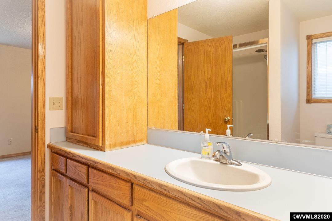 244 Edwards Road South Monmouth, OR 97361 - Photo 21 of 29 a bathroom with a granite countertop sink and a mirror