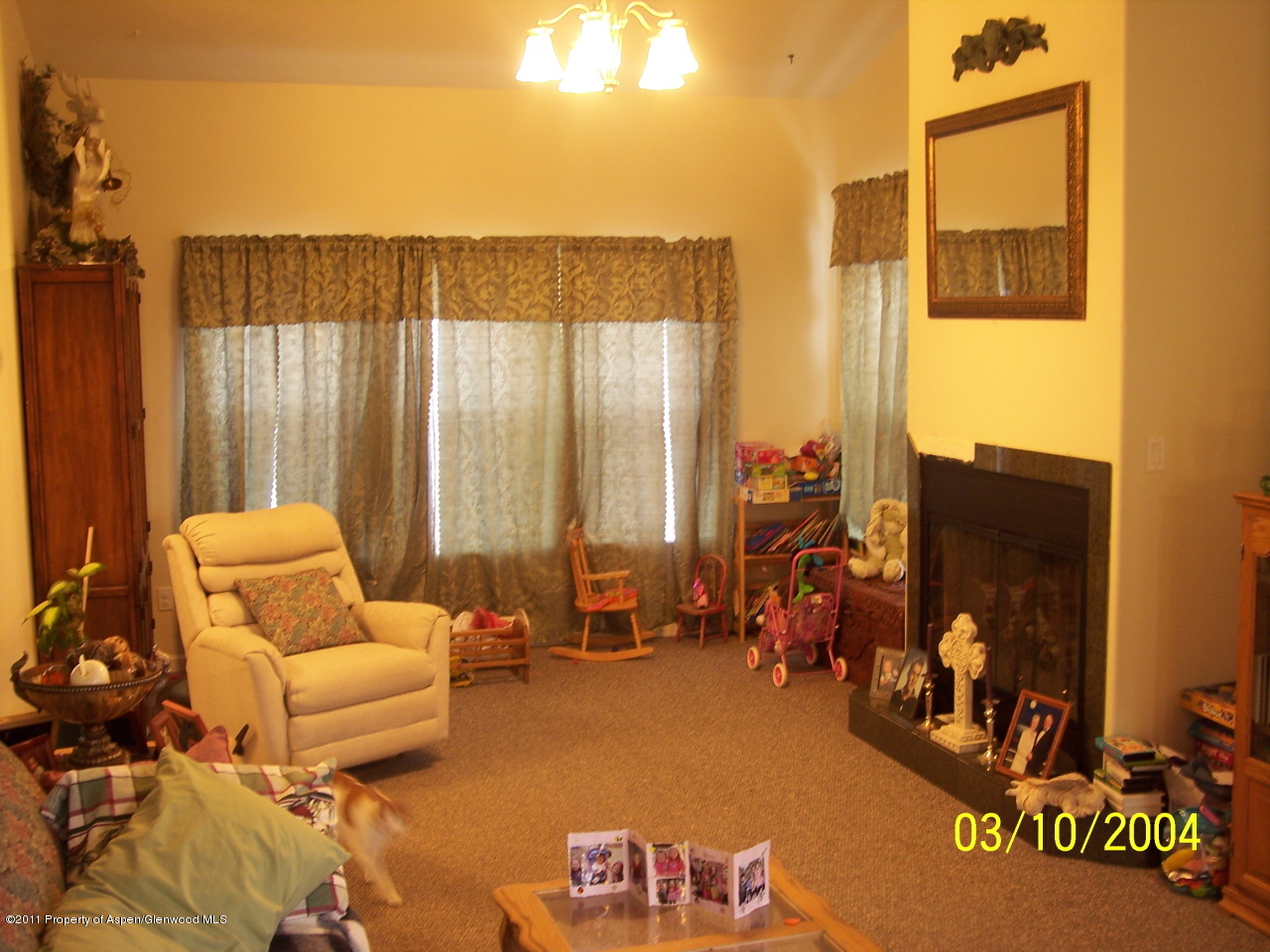 1292 East 18th Way Rifle, CO 81650 - Photo 2 of 6 a living room with furniture and a floor to ceiling window