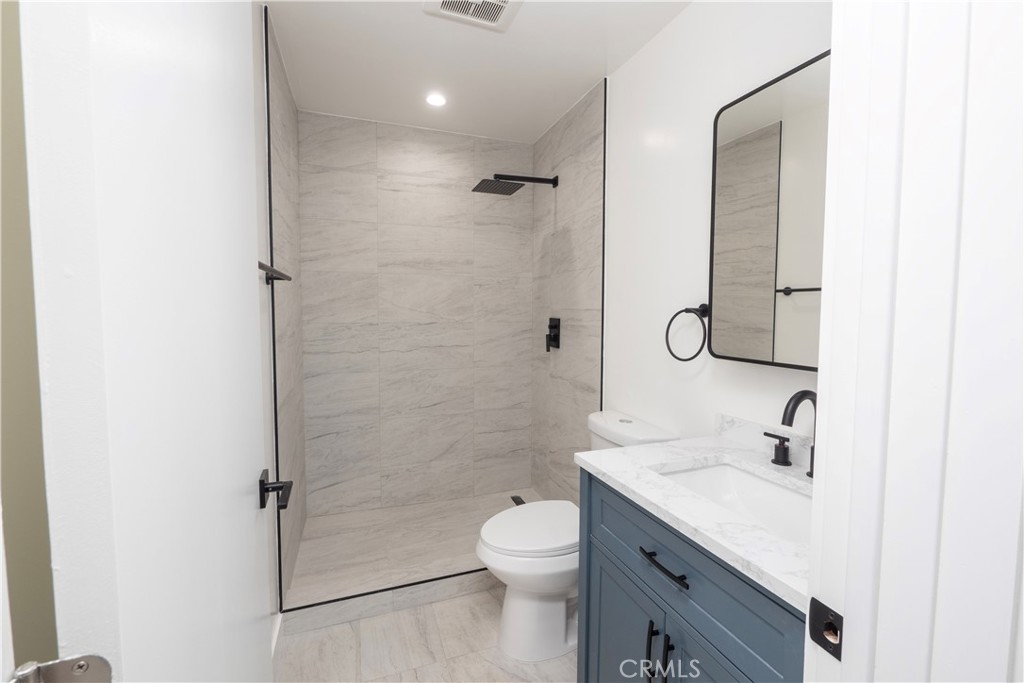 1571 Ricardo Street Los Angeles, CA 90033 - Photo 24 of 29 a bathroom with a granite countertop toilet sink and shower