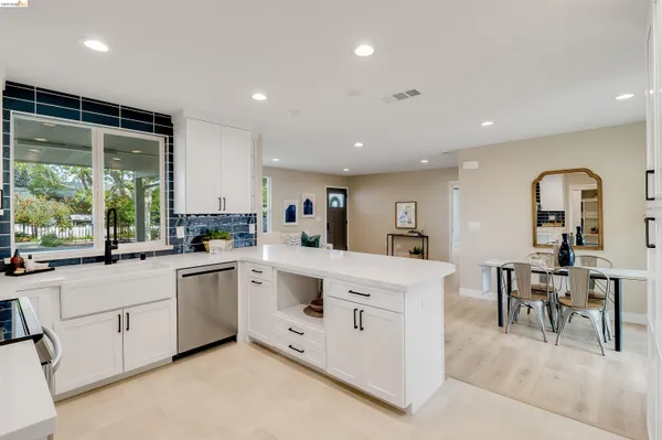 a kitchen with a sink stove and cabinets
