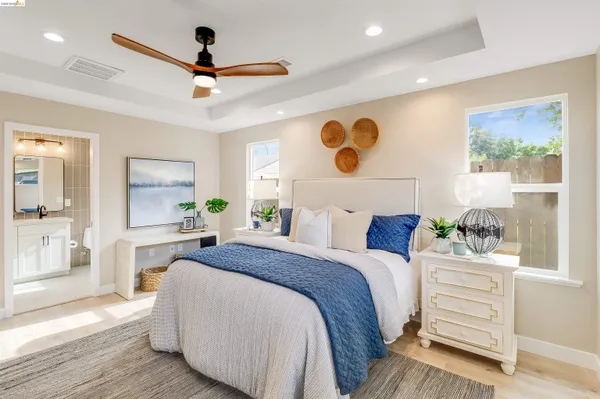 a bedroom with a bed and a view of living room