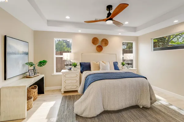 a bedroom with a bed and a view of kitchen