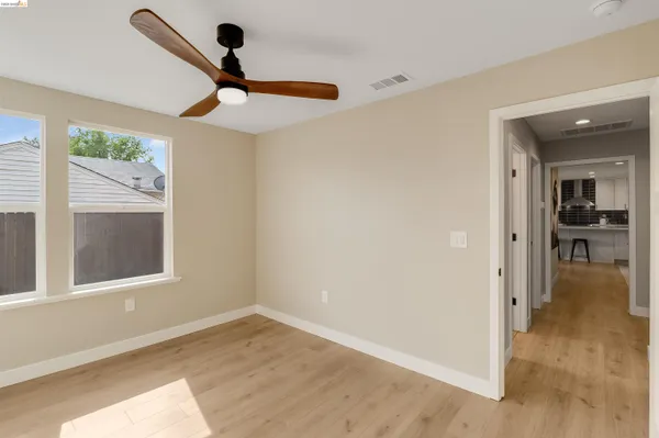 a front view of a house with yard and potted plants