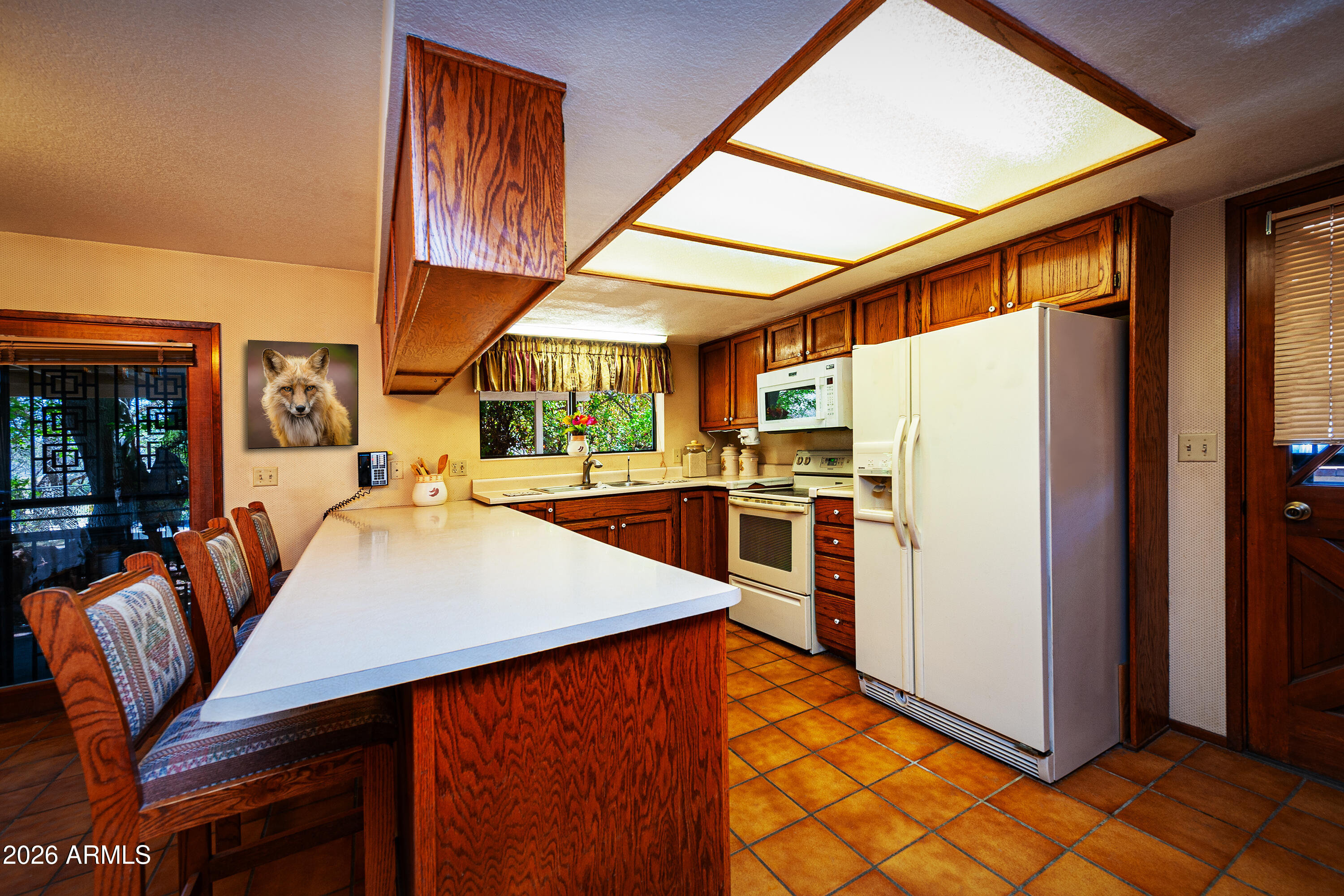 1945 South Loy Road Cornville, AZ 86325 - Photo 5 of 47 a kitchen with stainless steel appliances kitchen island granite countertop dining table and chairs