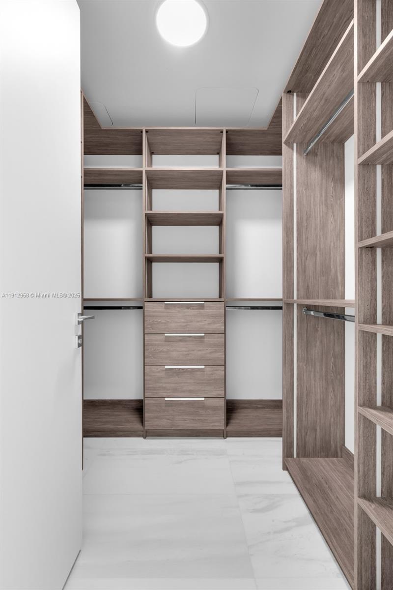 300 Biscayne Blvd Way, Unit 3009 Miami, FL 33131 - Photo 14 of 52 a view of walk in closet with empty racks