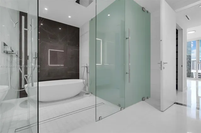 a white toilet sitting next to a white wall