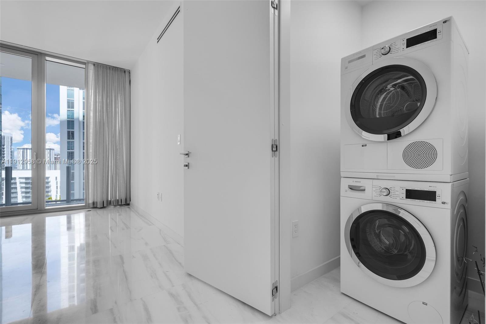300 Biscayne Blvd Way, Unit 3009 Miami, FL 33131 - Photo 23 of 52 a view of a hallway with washer and dryer