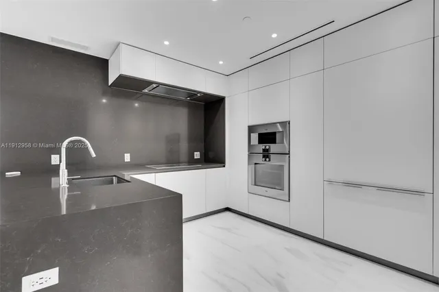 a modern kitchen with stainless steel appliances kitchen island a large counter top