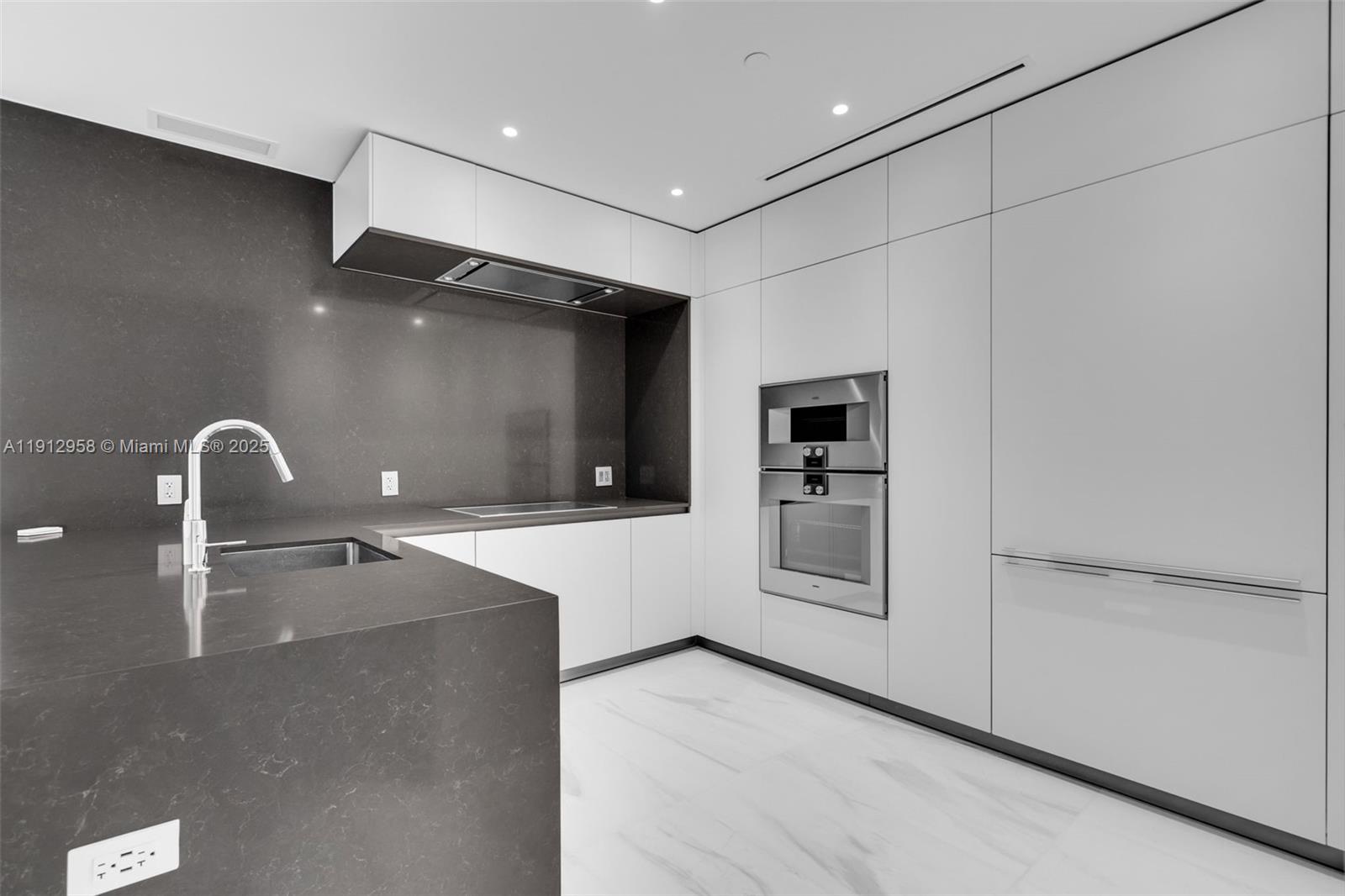 300 Biscayne Blvd Way, Unit 3009 Miami, FL 33131 - Photo 7 of 52 a modern kitchen with stainless steel appliances kitchen island a large counter top