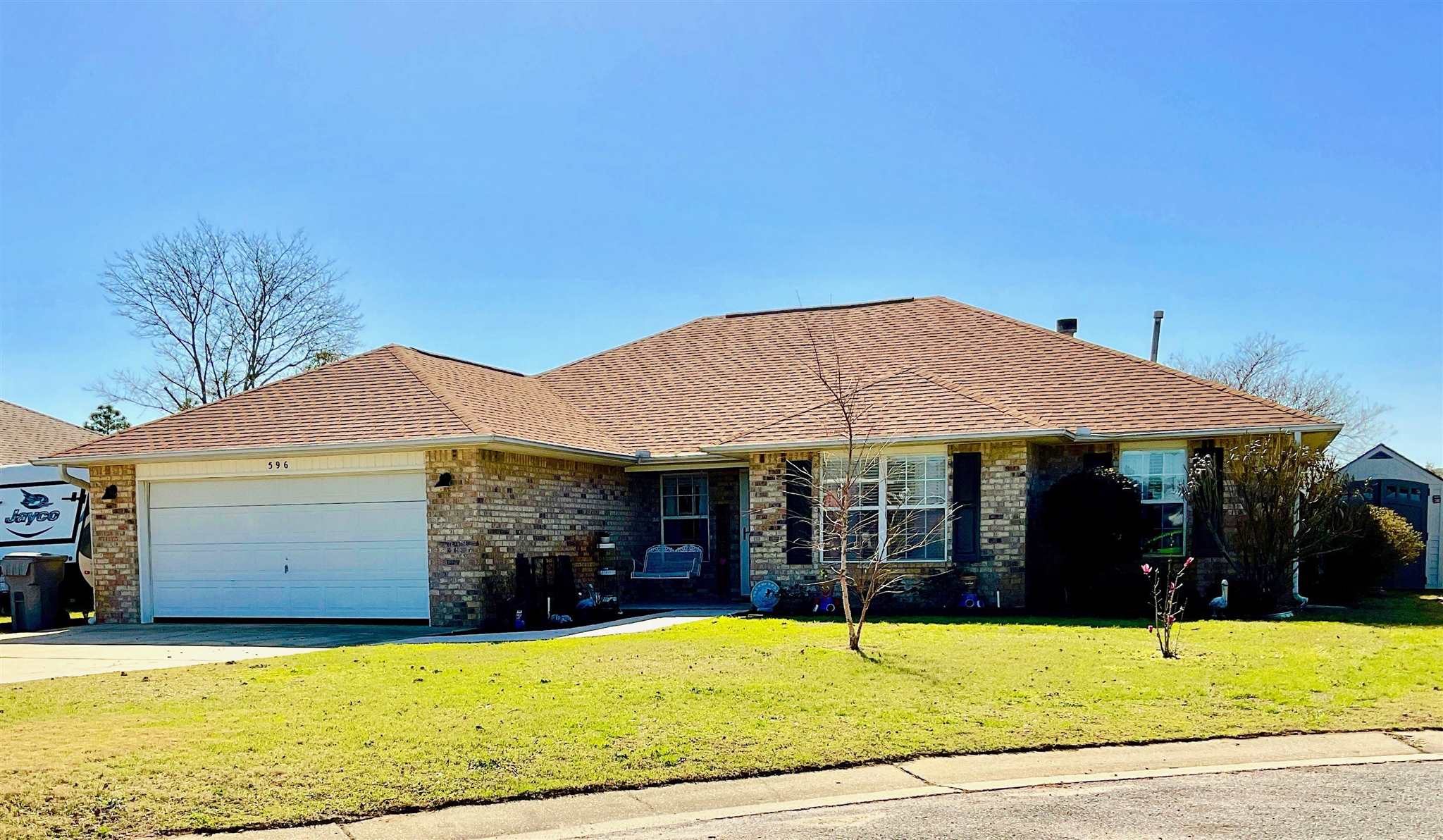 a view of a house with pool and sitting area