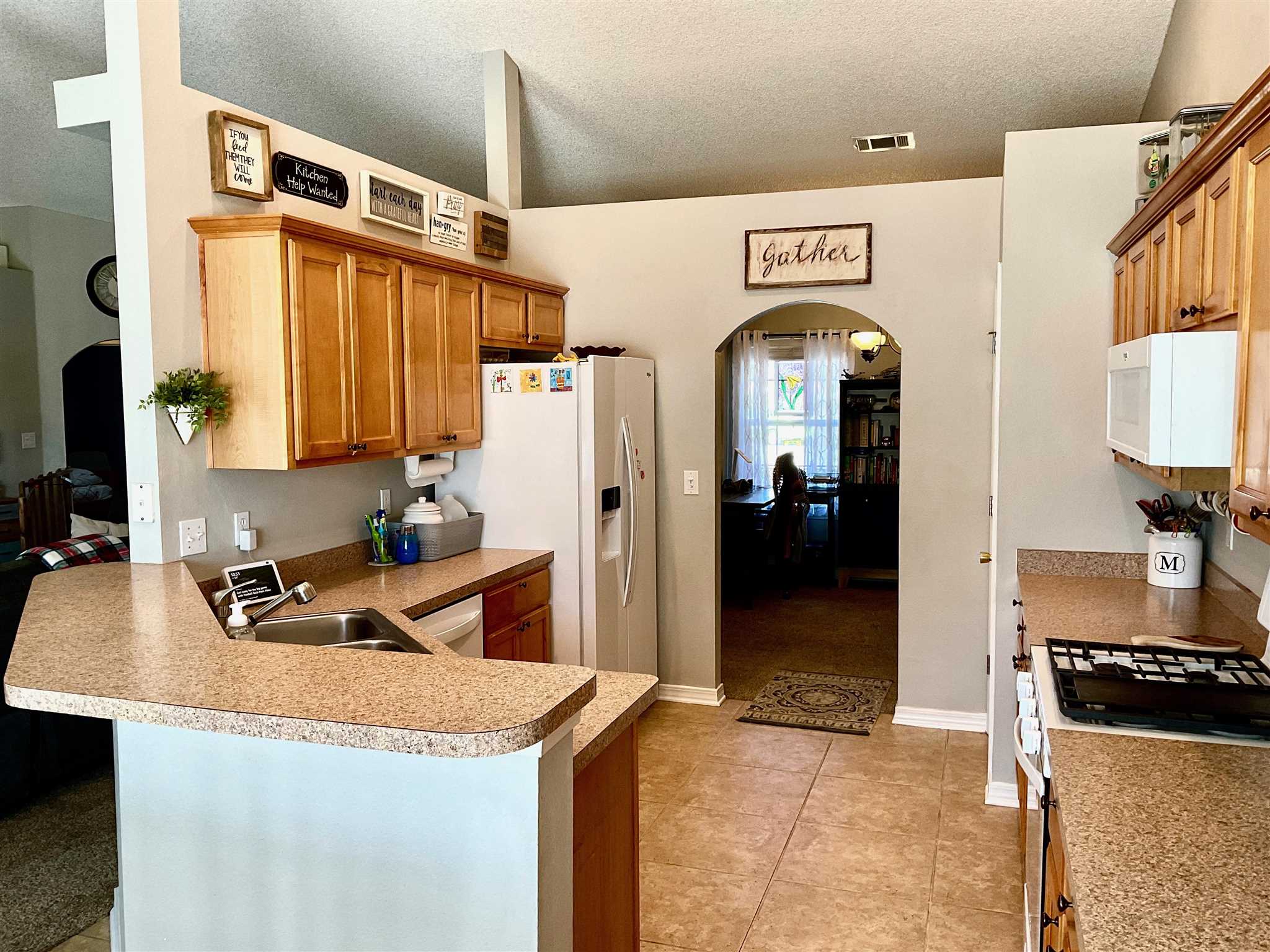 596 Batten Boulevard Pensacola, FL 32507 - Photo 16 of 48 a kitchen with stainless steel appliances granite countertop a refrigerator a stove and a sink
