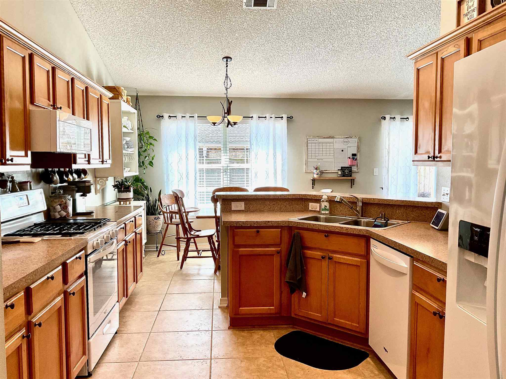 596 Batten Boulevard Pensacola, FL 32507 - Photo 17 of 48 a kitchen with stainless steel appliances a sink stove and a refrigerator