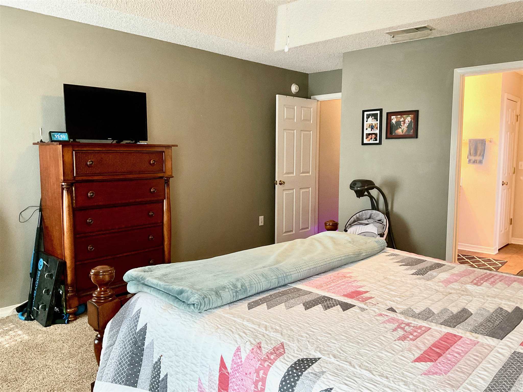 596 Batten Boulevard Pensacola, FL 32507 - Photo 22 of 48 a bedroom with a bed and a flat screen tv