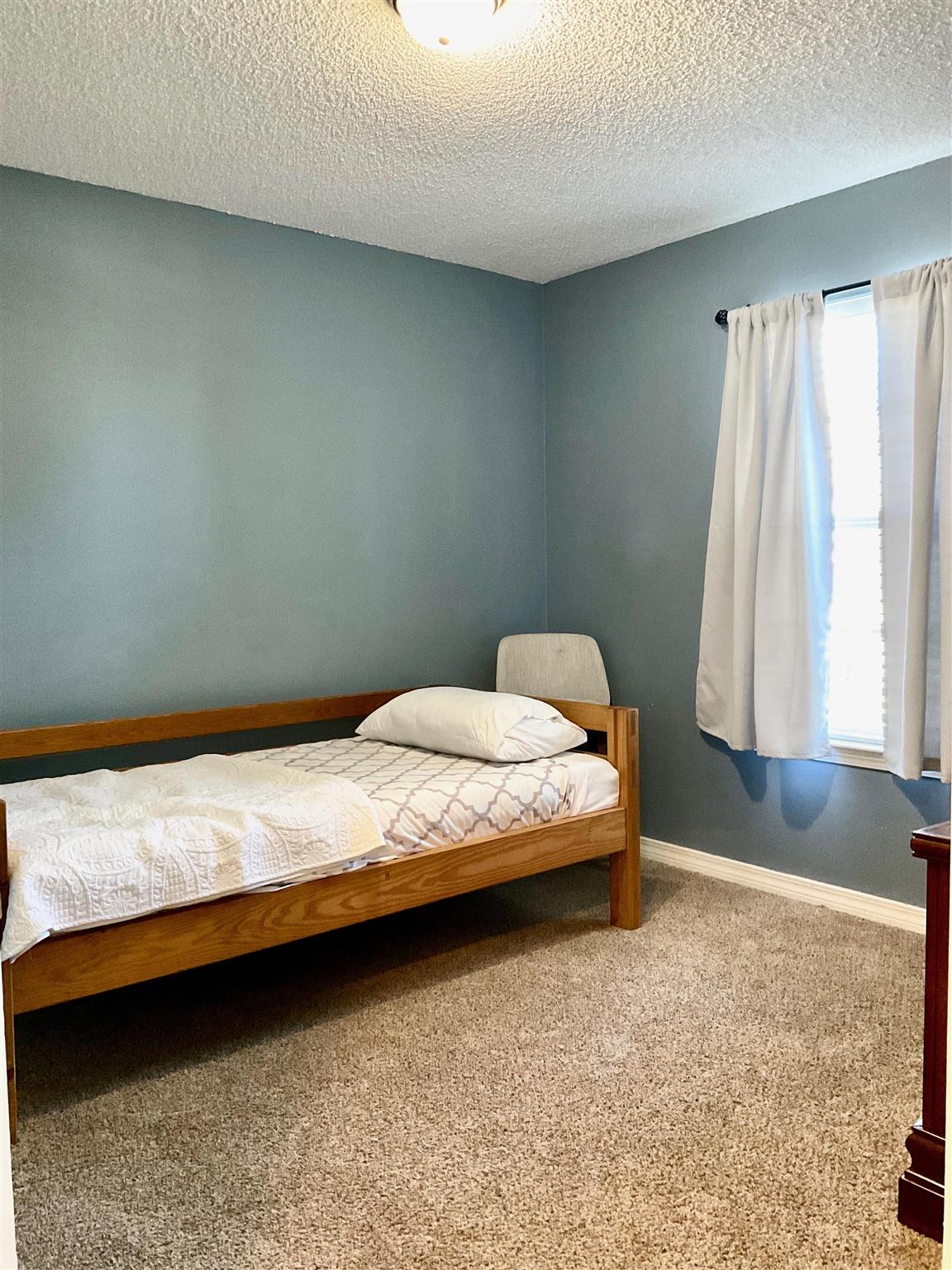 596 Batten Boulevard Pensacola, FL 32507 - Photo 29 of 48 a bedroom with a bed and window