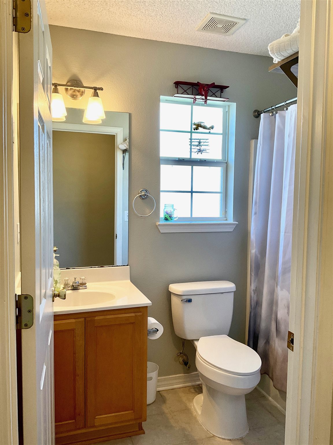 596 Batten Boulevard Pensacola, FL 32507 - Photo 33 of 48 a bathroom with a sink mirror and toilet