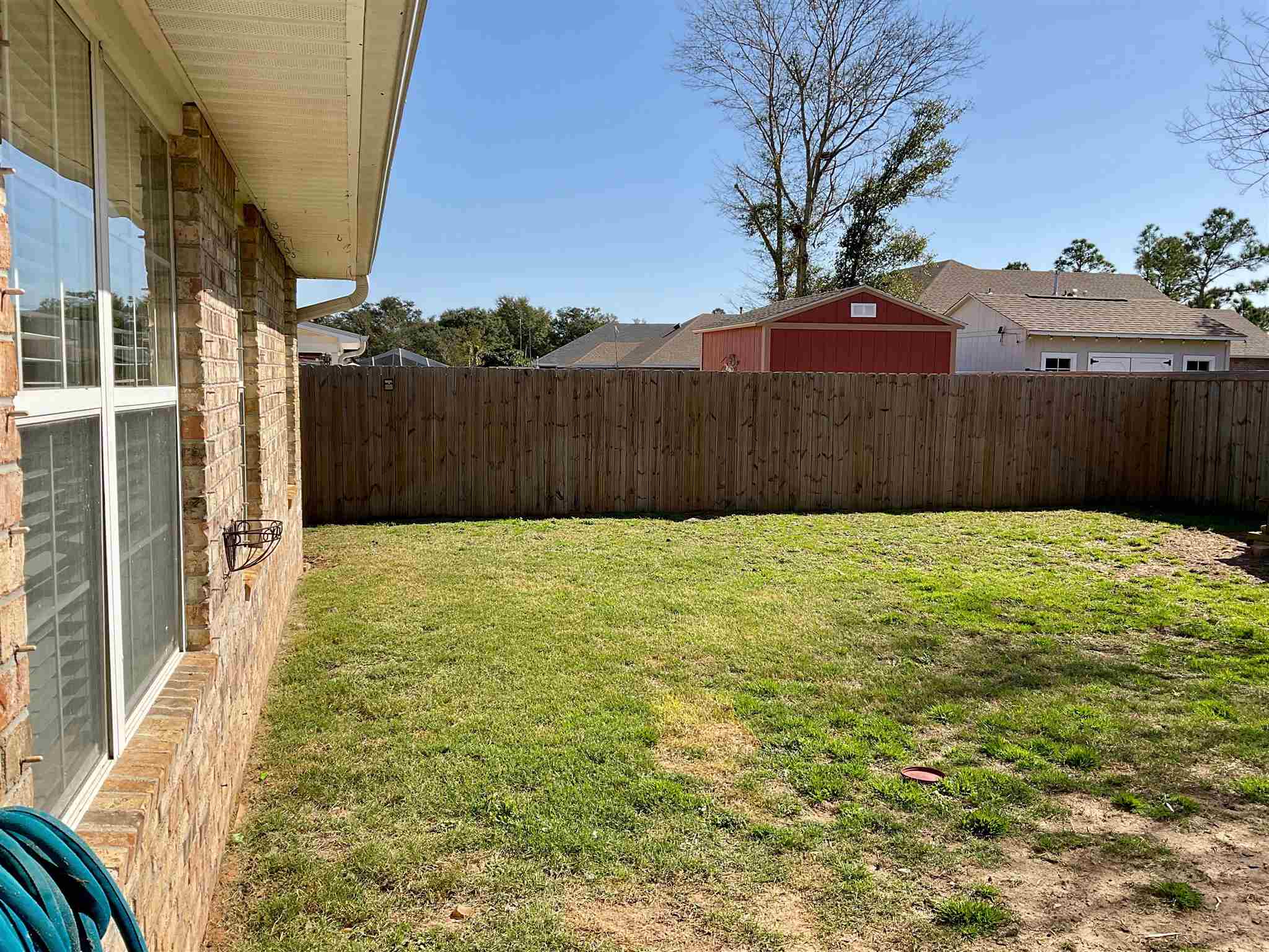 596 Batten Boulevard Pensacola, FL 32507 - Photo 44 of 48 a big yard with table and wooden fence