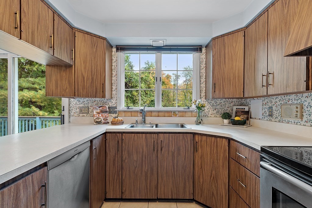 22 Sunset Rock Road Andover, MA 01810 - Photo 11 of 38 a kitchen with a sink a window and cabinets