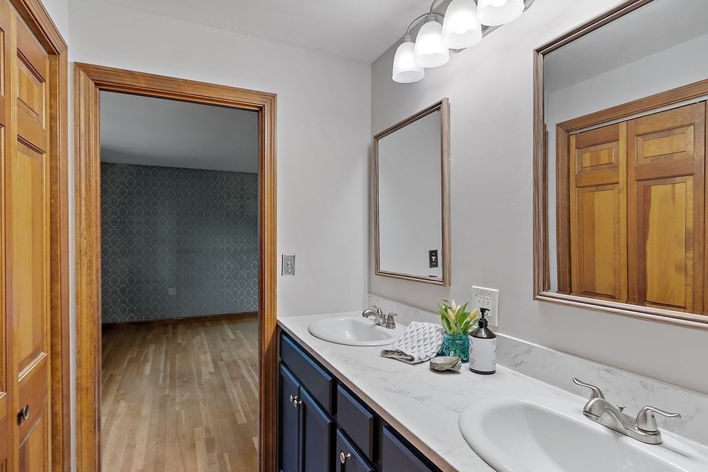 22 Sunset Rock Road Andover, MA 01810 - Photo 15 of 38 a bathroom with a sink vanity granite and a mirror