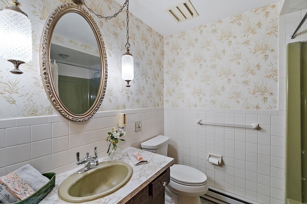 22 Sunset Rock Road Andover, MA 01810 - Photo 19 of 38 a bathroom with a sink a toilet and a mirror