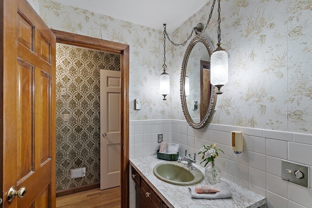 22 Sunset Rock Road Andover, MA 01810 - Photo 20 of 38 a bathroom with a sink a toilet and mirror