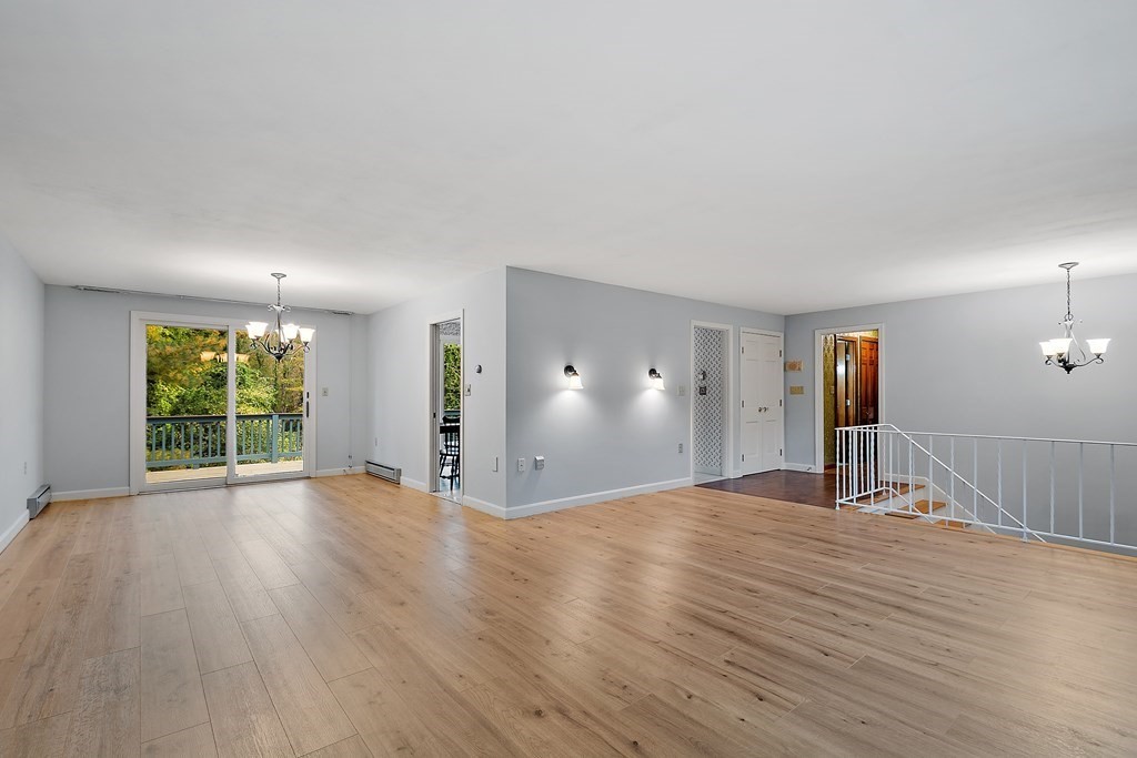 22 Sunset Rock Road Andover, MA 01810 - Photo 5 of 38 a view of empty room with wooden floor and fan