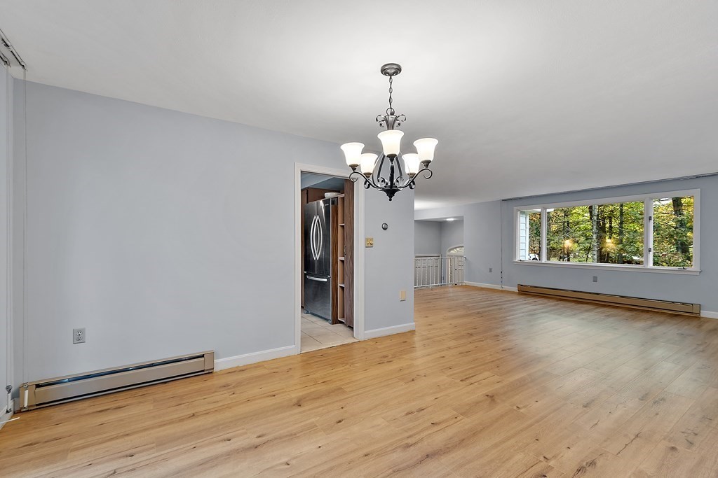 22 Sunset Rock Road Andover, MA 01810 - Photo 6 of 38 a view of a livingroom with a chandelier wooden floor and chandelier