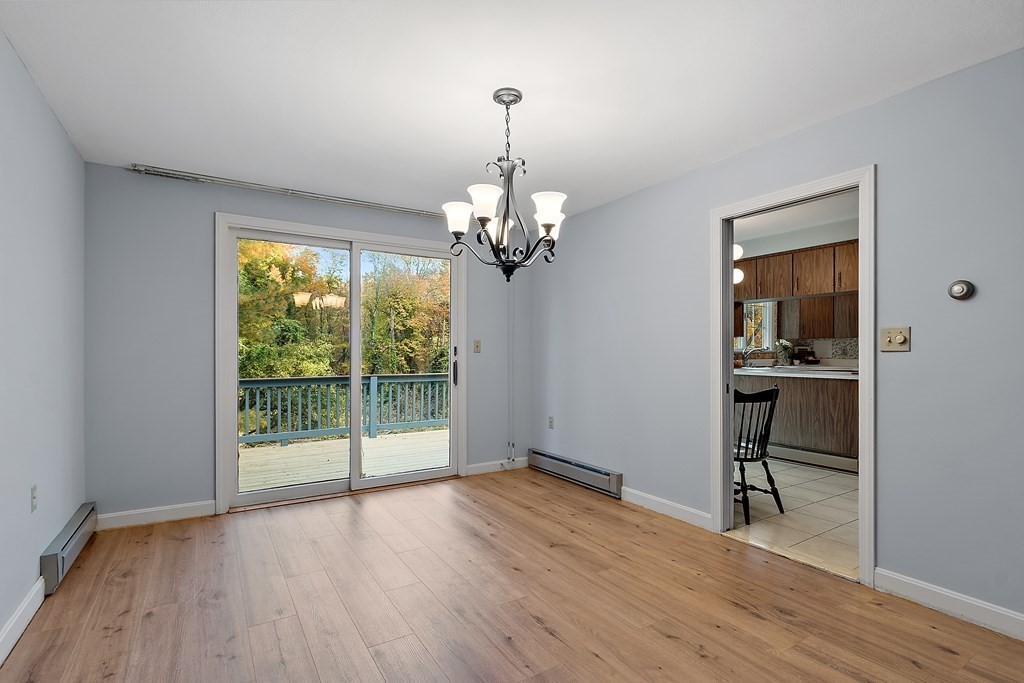 22 Sunset Rock Road Andover, MA 01810 - Photo 7 of 38 a view of a room with wooden floor chandeliers and kitchen