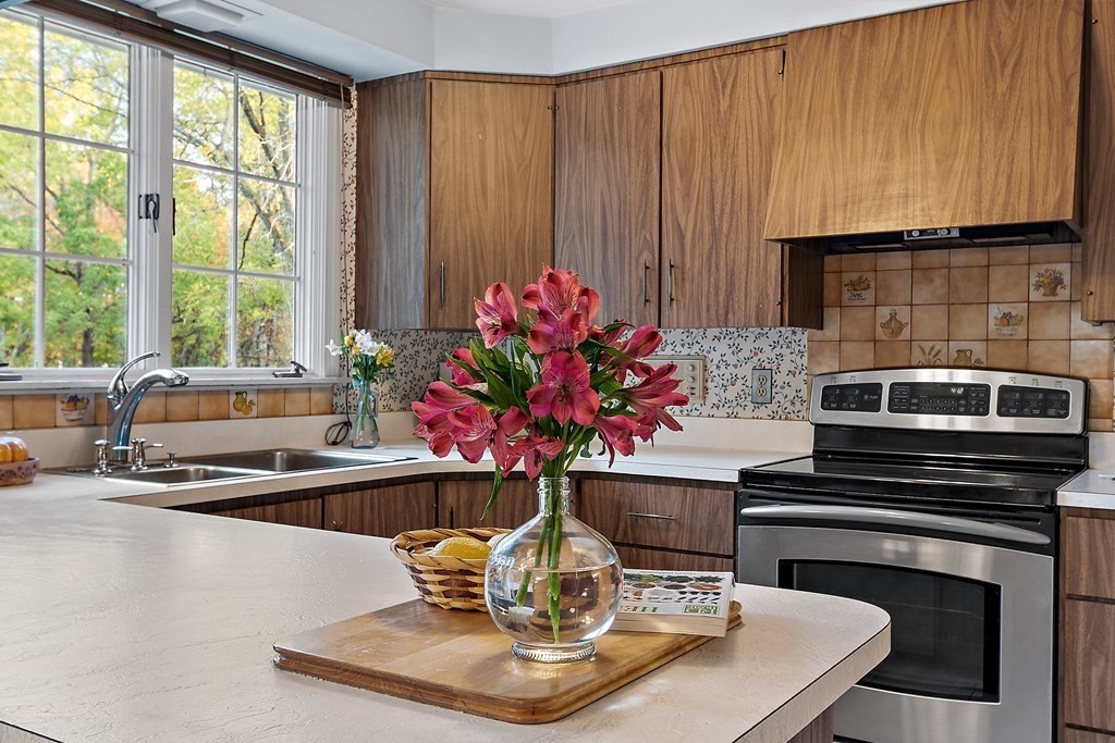 22 Sunset Rock Road Andover, MA 01810 - Photo 10 of 38 a dining table with a fireplace and a window