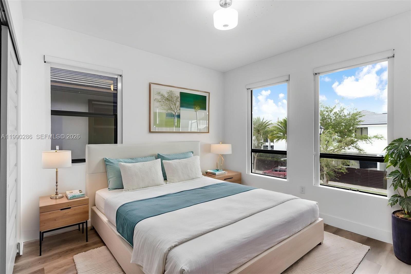 16058 Southwest 136 Way Miami, FL 33196 - Photo 17 of 21 a bedroom with a large bed and a large window