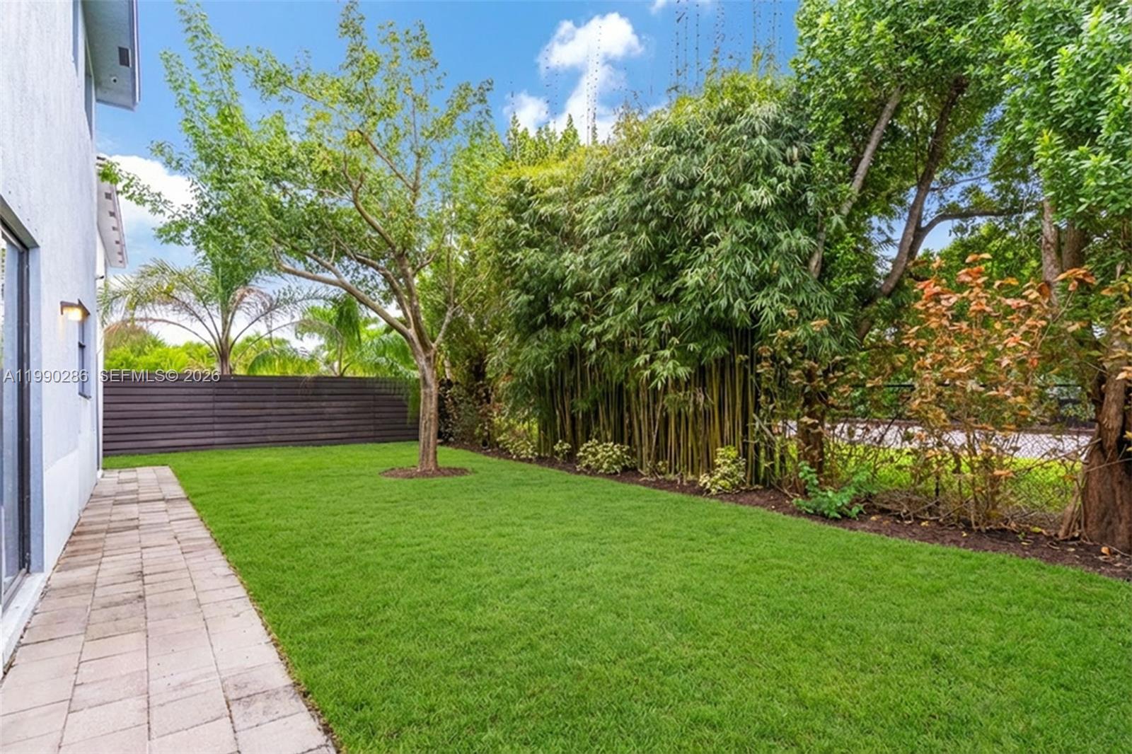16058 Southwest 136 Way Miami, FL 33196 - Photo 19 of 21 a backyard of a house with lots of green space