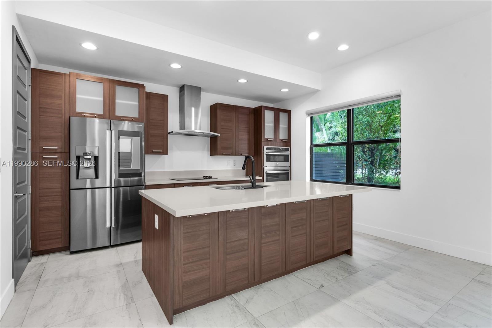16058 Southwest 136 Way Miami, FL 33196 - Photo 6 of 21 a kitchen with stainless steel appliances granite countertop a sink stove and refrigerator