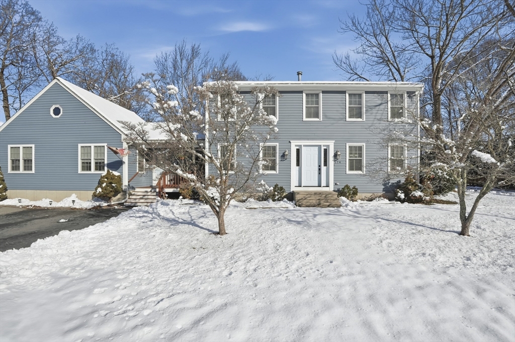 a view of a house with snow on the road